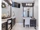 Bright bathroom featuring dual vanities, marble countertops, tile floors, and a large mirror with vanity seating at 309 Shoreline Dr, Princeton, NC 27569