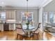 Dining area featuring a glass table and upholstered seating near the kitchen at 309 Shoreline Dr, Princeton, NC 27569
