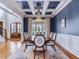 Elegant dining room with wainscoting, coffered ceiling, chandelier, and ample seating for formal gatherings at 309 Shoreline Dr, Princeton, NC 27569