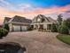 A charming two-story brick home featuring a spacious driveway and manicured landscaping at 309 Shoreline Dr, Princeton, NC 27569