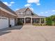 Impressive brick home with a three-car garage and inviting front porch with grand white pillars at 309 Shoreline Dr, Princeton, NC 27569