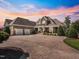 Beautiful brick home with a large driveway, manicured lawn, and a welcoming front porch with stone pillars at 309 Shoreline Dr, Princeton, NC 27569