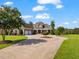 Gorgeous brick home with a three-car garage, manicured lawn, and a circular driveway perfect for guests at 309 Shoreline Dr, Princeton, NC 27569