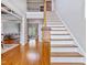 Elegant foyer featuring hardwood floors, staircase, and views into the living spaces at 309 Shoreline Dr, Princeton, NC 27569