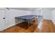 Finished attic space with hardwood floors and a ping pong table provides a fun recreational area at 309 Shoreline Dr, Princeton, NC 27569