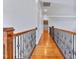 Upstairs hallway featuring hardwood floors and decorative metal railing at 309 Shoreline Dr, Princeton, NC 27569