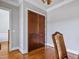 Hallway with hardwood floors, white trim, and wooden double doors at 309 Shoreline Dr, Princeton, NC 27569