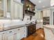 Kitchen featuring custom cabinets, hardwood floors, granite countertops, and stainless steel appliances at 309 Shoreline Dr, Princeton, NC 27569