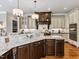 Kitchen featuring a center island with seating, custom cabinets, hardwood floors, and granite countertops at 309 Shoreline Dr, Princeton, NC 27569