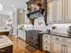 Kitchen featuring custom cabinets, hardwood floors, granite countertops, and stainless steel appliances at 309 Shoreline Dr, Princeton, NC 27569