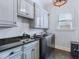 Functional laundry room with a utility sink, washer, dryer, and elegant overhead cabinets at 309 Shoreline Dr, Princeton, NC 27569