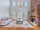 Bright living room featuring hardwood floors, stone fireplace, and large windows at 309 Shoreline Dr, Princeton, NC 27569