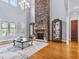 Bright, open living room with high ceilings, large windows, fireplace, and hardwood floors, perfect for entertaining at 309 Shoreline Dr, Princeton, NC 27569
