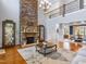 Open-concept living room with a floor-to-ceiling stone fireplace and hardwood floors at 309 Shoreline Dr, Princeton, NC 27569