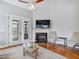 Bright living room boasts a fireplace, hardwood floors, and French doors leading to outdoor space at 309 Shoreline Dr, Princeton, NC 27569