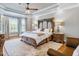 Spacious bedroom featuring a large bed, decorative rug, and tray ceiling with fan at 309 Shoreline Dr, Princeton, NC 27569