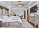 Serene main bedroom with a decorative dresser, ceiling fan and a seating area at 309 Shoreline Dr, Princeton, NC 27569