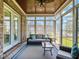 Comfortable sunroom with brick accents and views, ideal for relaxing or entertaining friends at 309 Shoreline Dr, Princeton, NC 27569