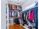 Spacious walk-in closet with custom shelving and hardwood floors at 309 Shoreline Dr, Princeton, NC 27569