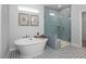 Contemporary bathroom with freestanding tub, glass enclosed shower, and patterned tile floor at 31 Priming Way, Angier, NC 27501