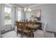 Dining room featuring stylish wallpaper, a wooden table with chairs and an elegant chandelier at 31 Priming Way, Angier, NC 27501