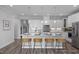 Bright kitchen features white cabinets, an island with seating, and stylish pendant lighting at 31 Priming Way, Angier, NC 27501