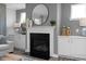 Cozy living room featuring a fireplace with built-in cabinets and a stylish round mirror at 31 Priming Way, Angier, NC 27501