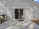 View of white siding, sliding glass doors to the deck, and the backyard at 312 Homestead Park Dr, Apex, NC 27502