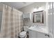Clean bathroom showcasing a vanity, toilet, shower with curtain, and a medicine cabinet for storage at 312 Homestead Park Dr, Apex, NC 27502