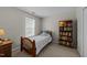 Minimal bedroom featuring a wooden bed frame, window and a full bookshelf at 312 Homestead Park Dr, Apex, NC 27502