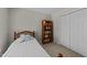 Cozy bedroom with a double closet, a wooden bed frame, and a bookcase at 312 Homestead Park Dr, Apex, NC 27502