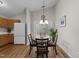 Charming dining area with a round table, four chairs, and a sliding door to the backyard at 312 Homestead Park Dr, Apex, NC 27502