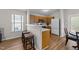 Open kitchen with breakfast bar, stainless steel appliances, and natural wood cabinetry at 312 Homestead Park Dr, Apex, NC 27502