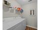 Functional laundry room equipped with a washer, dryer, and shelving for storage at 312 Homestead Park Dr, Apex, NC 27502