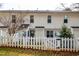 Back exterior view of the townhome, showcasing a white picket fence at 3122 Coxindale Dr, Raleigh, NC 27615