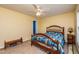 Bright bedroom with blue quilt, ceiling fan, and natural light at 3122 Coxindale Dr, Raleigh, NC 27615