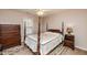 Comfortable bedroom features natural light and dark wood furniture at 3122 Coxindale Dr, Raleigh, NC 27615
