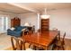 Dining room featuring hardwood floors, a large dining table, and seamless access to the living room at 3122 Coxindale Dr, Raleigh, NC 27615