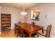Dining room with wooden floors, a large dining table, and access to the kitchen through an open layout at 3122 Coxindale Dr, Raleigh, NC 27615
