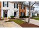Well-kept townhomes showcase a mix of brick and siding, enhanced by lush landscaping and mature trees at 3122 Coxindale Dr, Raleigh, NC 27615