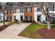 A row of charming townhomes featuring well-manicured front lawns, mature trees, and inviting entrances at 3122 Coxindale Dr, Raleigh, NC 27615