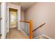 Hallway features wood railing and neutral carpet at 3122 Coxindale Dr, Raleigh, NC 27615