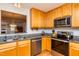 Efficient kitchen featuring stone countertops, stainless steel appliances, and wood cabinets at 3122 Coxindale Dr, Raleigh, NC 27615
