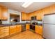 Updated kitchen with stainless steel appliances, granite countertops, and warm wood cabinets at 3122 Coxindale Dr, Raleigh, NC 27615