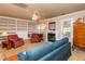 Cozy living room featuring a fireplace, built-in bookshelves, ceiling fan, and comfortable seating arrangement at 3122 Coxindale Dr, Raleigh, NC 27615