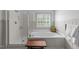 Bright bathroom featuring a soaking tub, a separate shower, and natural light at 3124 Elm Tree Ln, Raleigh, NC 27614
