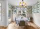 Bright dining area featuring a table for four, hardwood floors, and views of the backyard at 3124 Elm Tree Ln, Raleigh, NC 27614