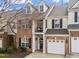 Charming brick townhouse featuring a one-car garage, small balcony, and inviting front entrance at 3124 Elm Tree Ln, Raleigh, NC 27614