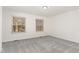 Spacious bedroom features gray carpet and natural light; awaiting your personal touch at 325 Bainbridge Cir, Garner, NC 27529