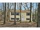 Charming two-story house with light yellow siding and black shutters surrounded by trees at 325 Bainbridge Cir, Garner, NC 27529